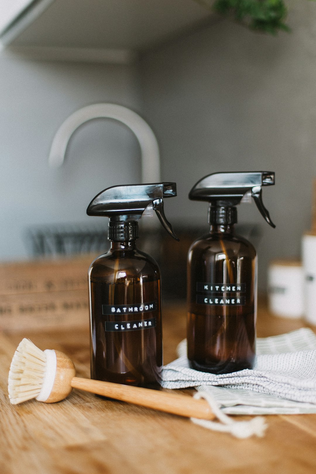 two-brown-spray-bottles-on-brown-table-uoomllxe6ge